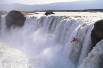 Shaun Baker kayaking Godafoss waterfall in Iceland